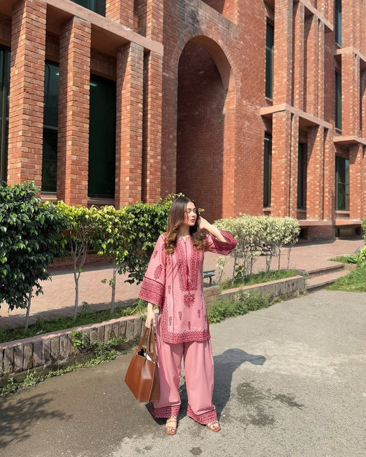 A Stylish Woman in Pink Pajamas Standing Gracefully