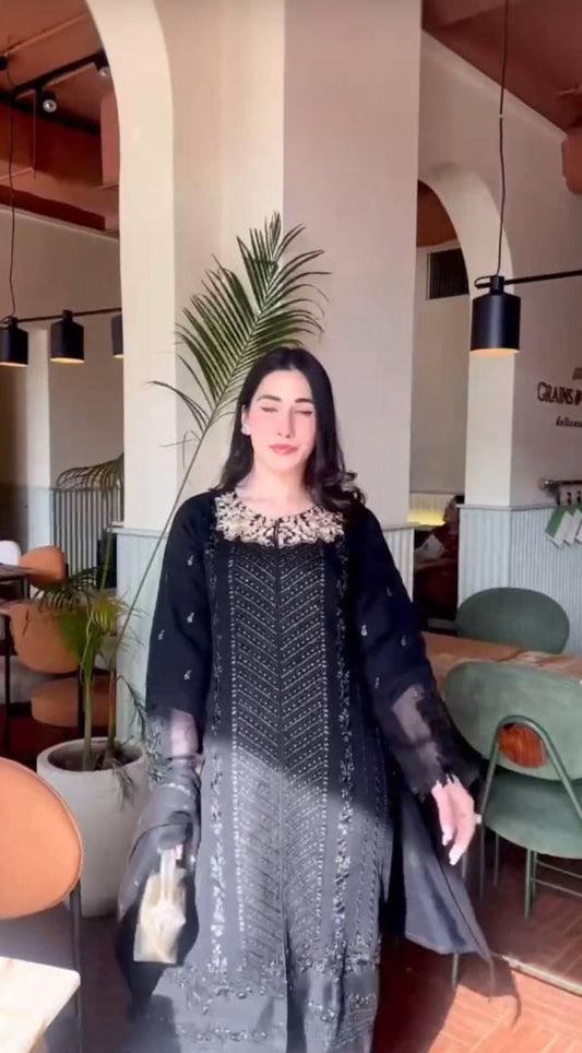 A Captivating Woman in a Black Dress Gracing the Ambiance